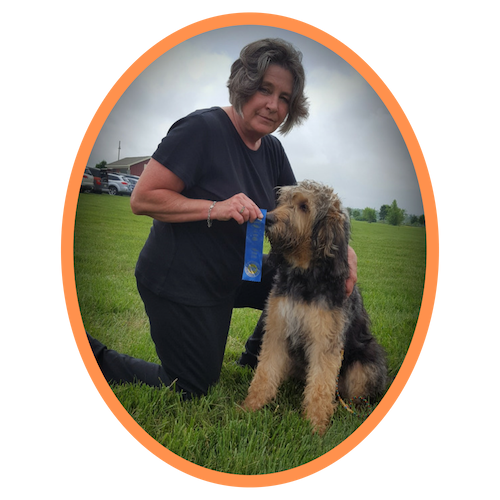 women with terrier and holding award